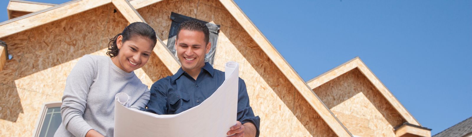 Couple looking over design plans for the home during construction