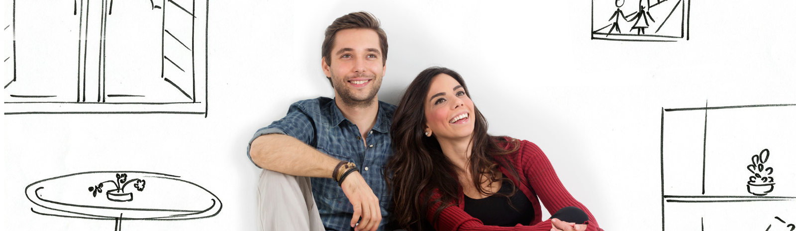 Couple sitting on floor with hand-drawn home interior illustrations, symbolizing home planning and future home ownership.