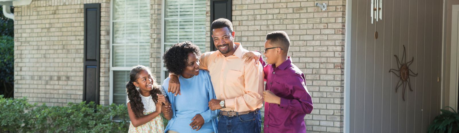 Family standing outside of their home