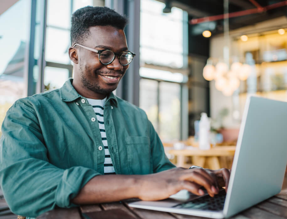 Man using a laptop in a cafe