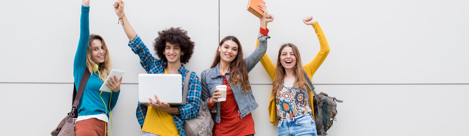 group of teenagers with arms raised above their heads