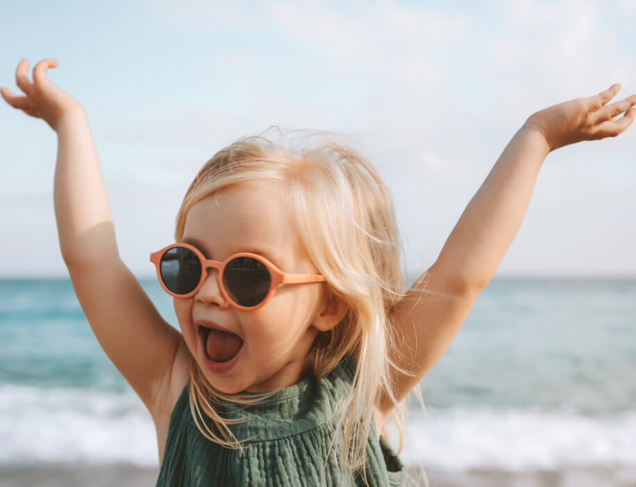 Young girl wearing sunglasses at the beach