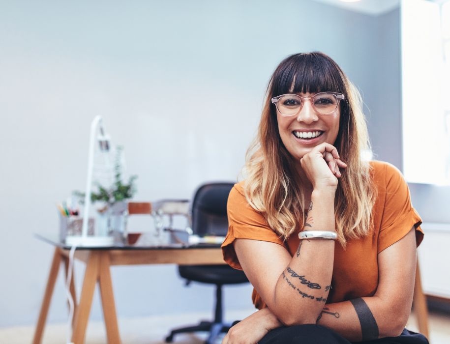 woman wearing glasses in sitting in front of desk