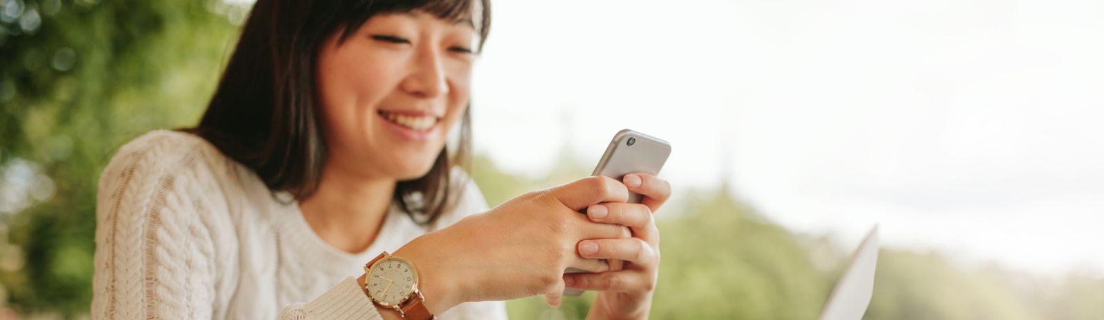 Woman wearing a watch while typing on her phone