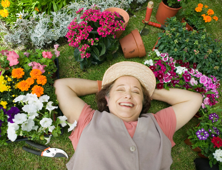 A person lying in the grass with her eyes closed