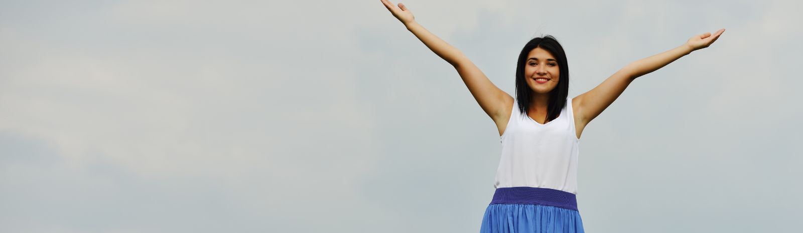 Woman raising arms to the sky