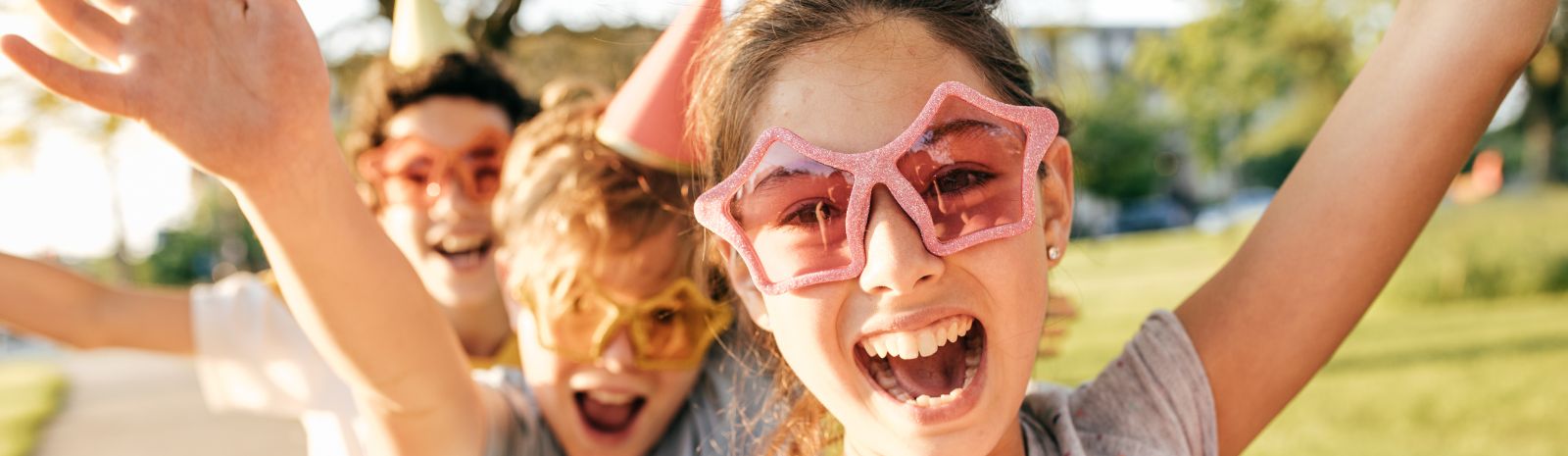 Kids wearing sunglasses and party attire 